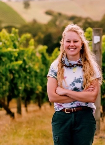 Jess Clark smiling outside in vineyard