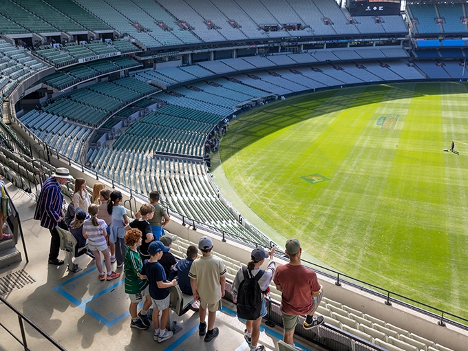 A group looks over the MCG arena from Level 4