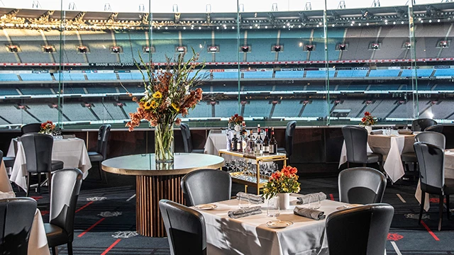 Formal restaurant dining with a view of MCG stands