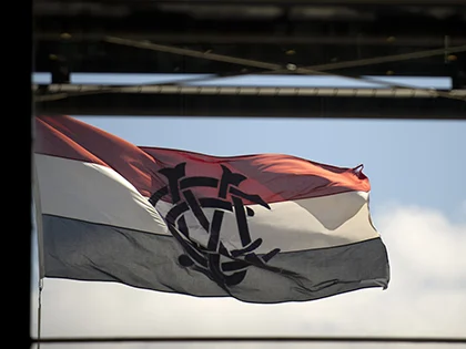 Red, white and black flag with MCC logo