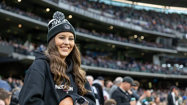 Smiling Collingwood fan in front of the Members' Reserve