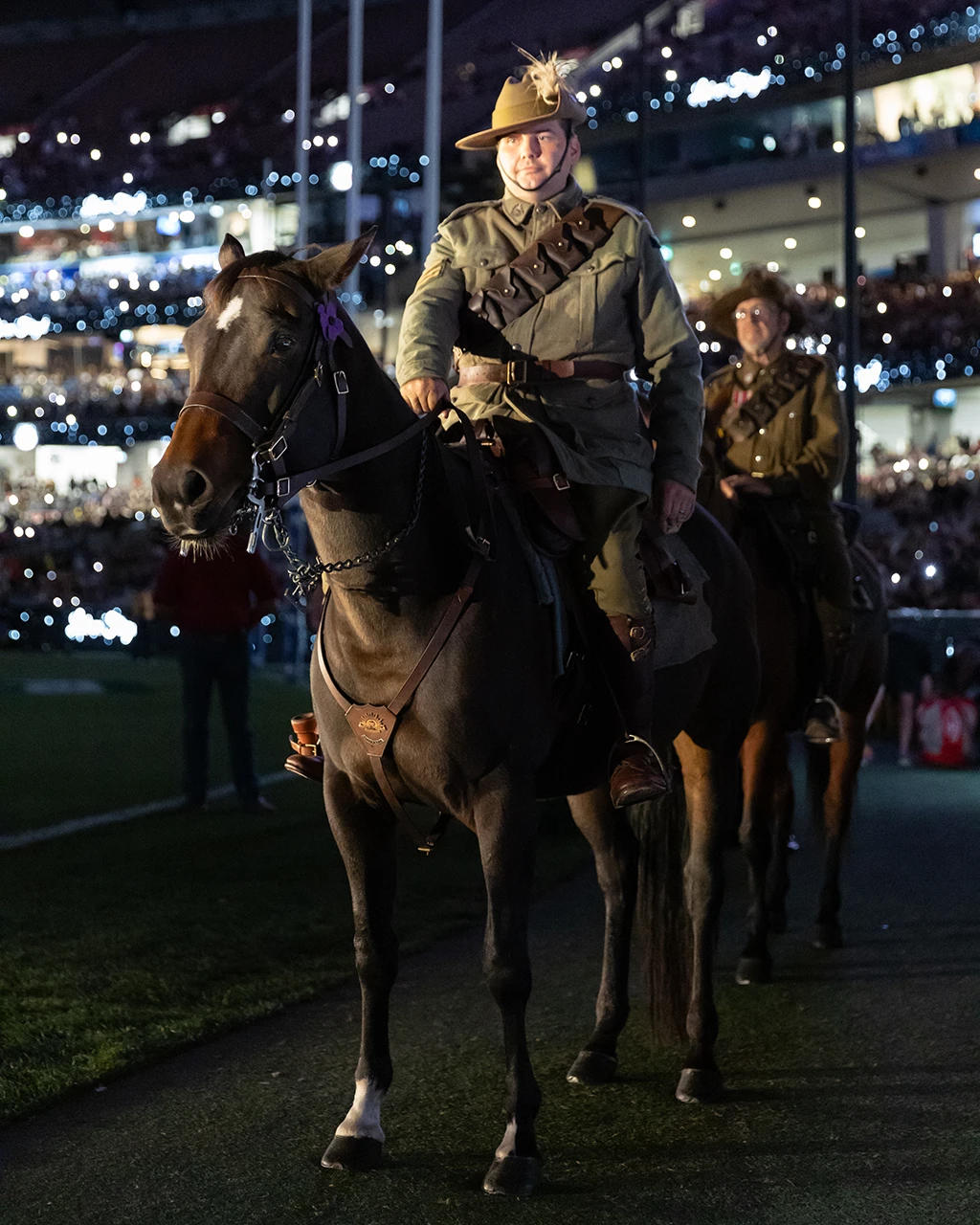 Military personnel on horses during ANZAC Day ceremony