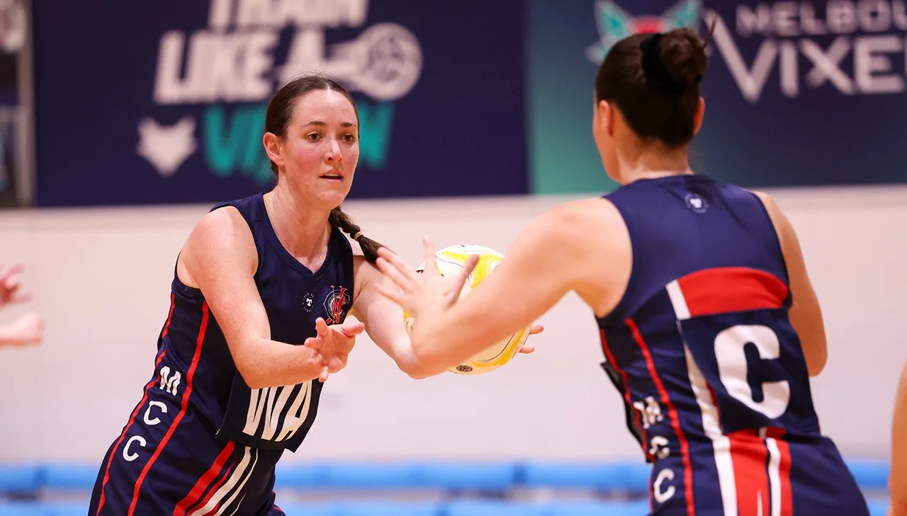 MCC Wing Attack passes netball to Centre team mate