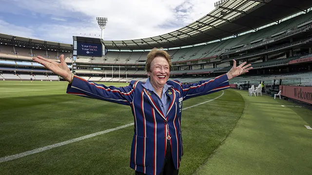 Tour guide has hands outstretched, showing the MCG boundary line