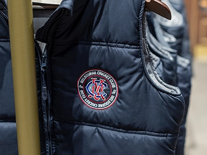 A navy MCC puffer vest for sale in the MCC merchandise store at the MCG