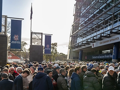 MCC members queue outside Gate 2 of the MCG