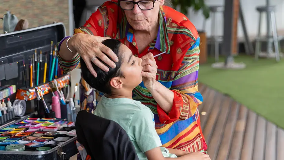 Children's face painting at the cricket