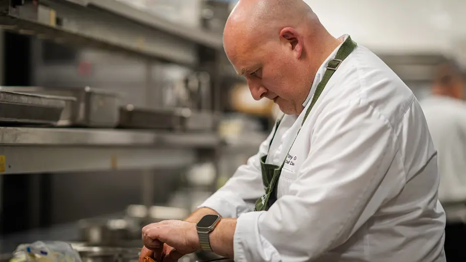 A chef cooking in the Committee Room by Grossi kitchen