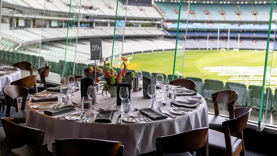Formal dining table set with MCG ground view through glass